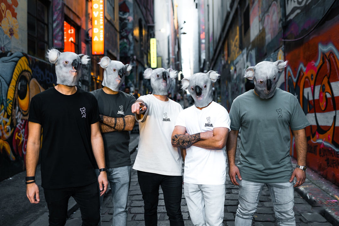 Group of five people wearing koala masks and Bogan Apparel T-shirts standing in a graffiti-covered Melbourne laneway.